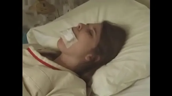 Stor Pretty brunette in Straitjacket taped mouth tied to bed hospital totalt rör